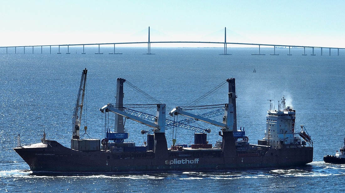 Two new cranes steam toward SeaPort Manatee after passing under the Sunshine Skyway Bridge.